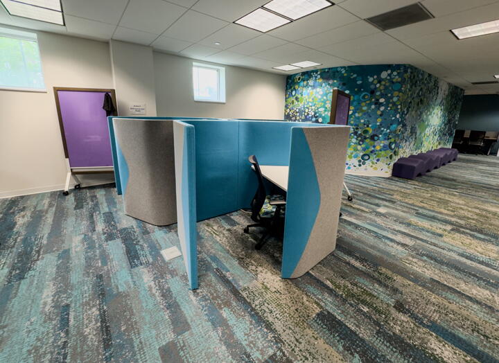Individual curved fabric work pod with desk and chair