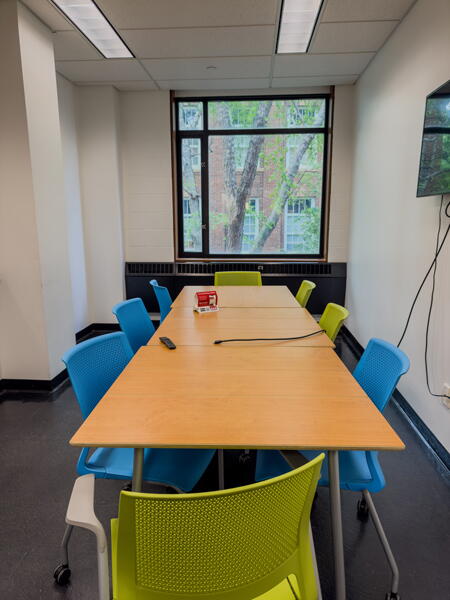 View of long conference room table with chairs and window