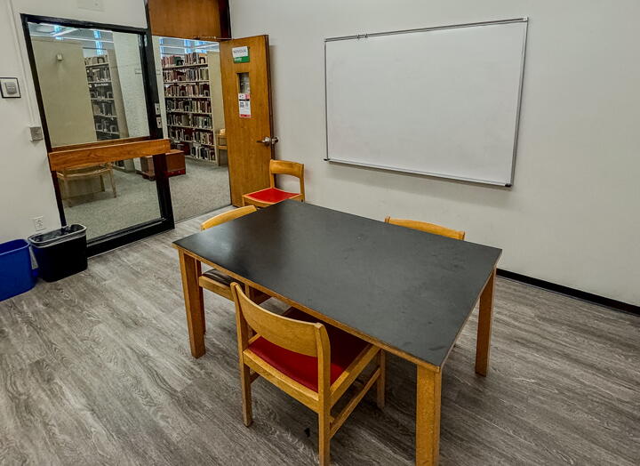 Study room with table and chairs and a wall-mounted whiteboard
