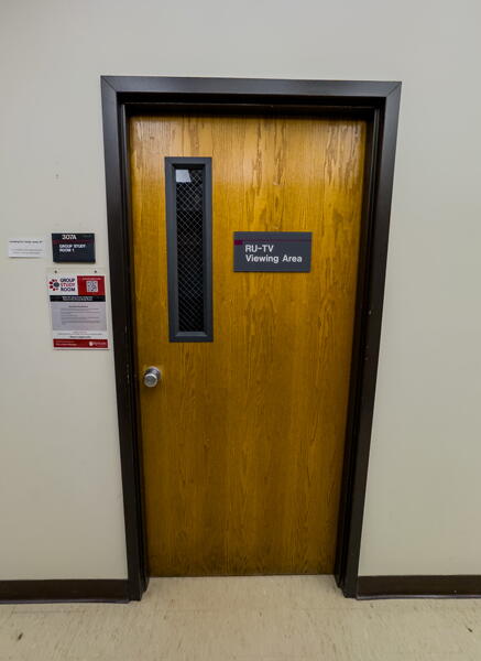 Closed door leading to Group Study Room 307A. Door has sign saying "RU-TV Viewing Area" 