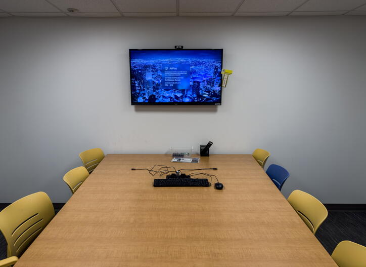 Group table and chairs with wall-mounted display with ApplePlay