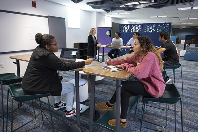 A group at one of the conference tables in the Hatchery