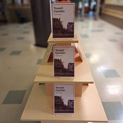 View of the Toward Camden display at Robeson Library featuring three images of the book cover