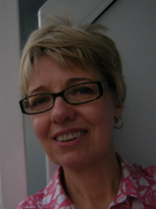 Photo of Rhonda, wearing a pink patterned collared shirt and black glasses