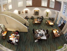 An overhead view of the Atrium at Alexander Library with groups of students studying at tables